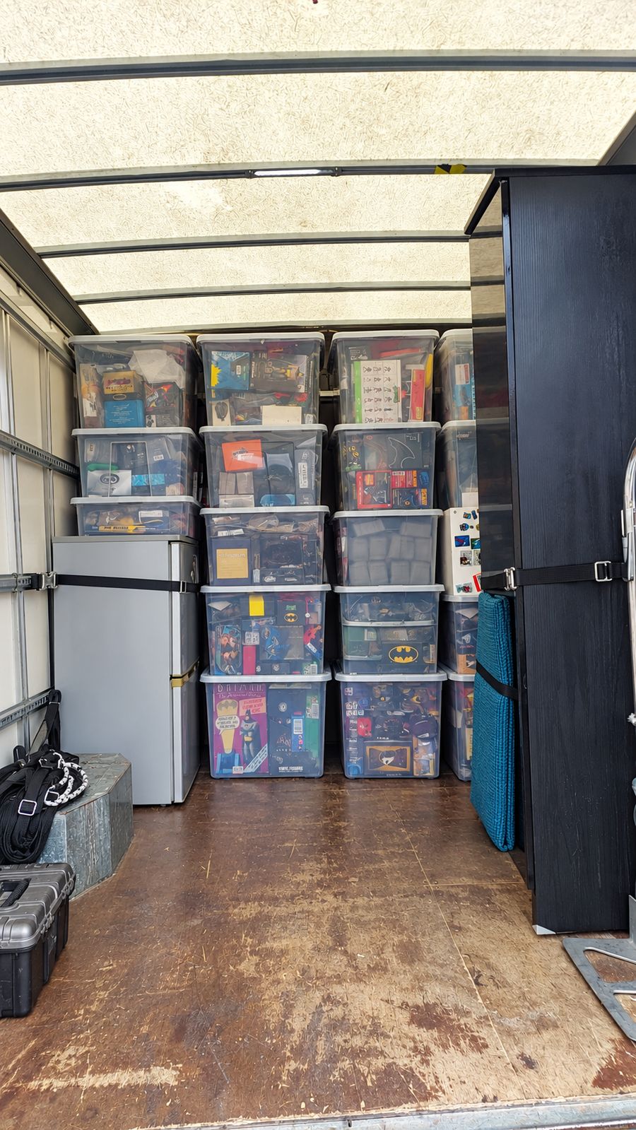 Stacked storage boxes, a fridge and a wardrobe secured in the van